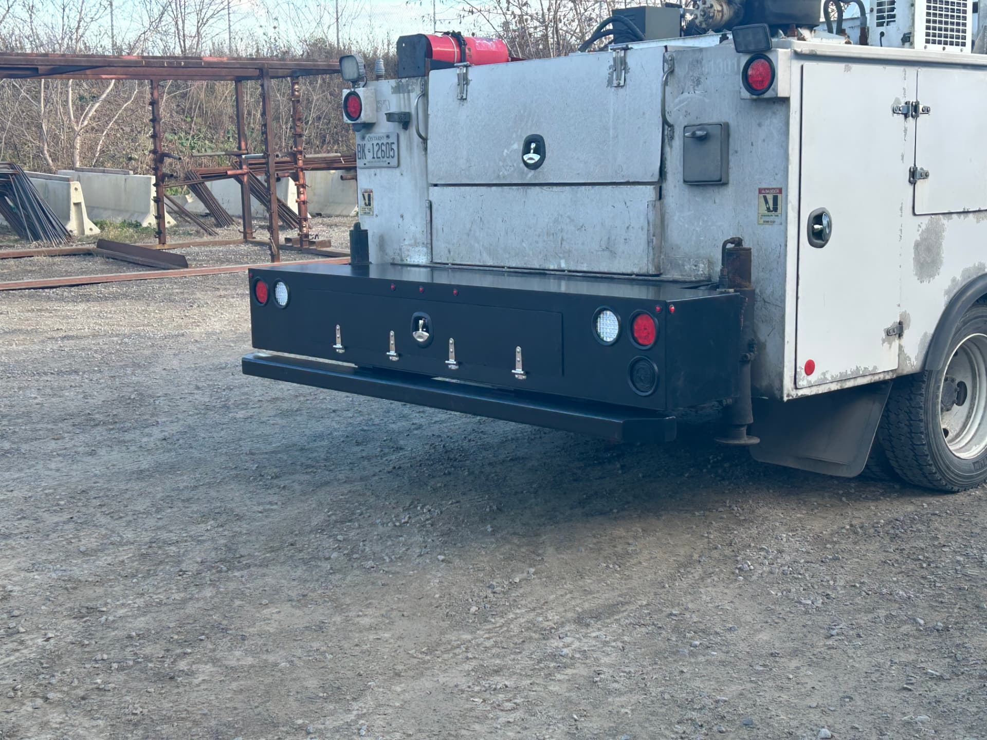 Utility truck with custom fabricated rear bumper and storage box installed