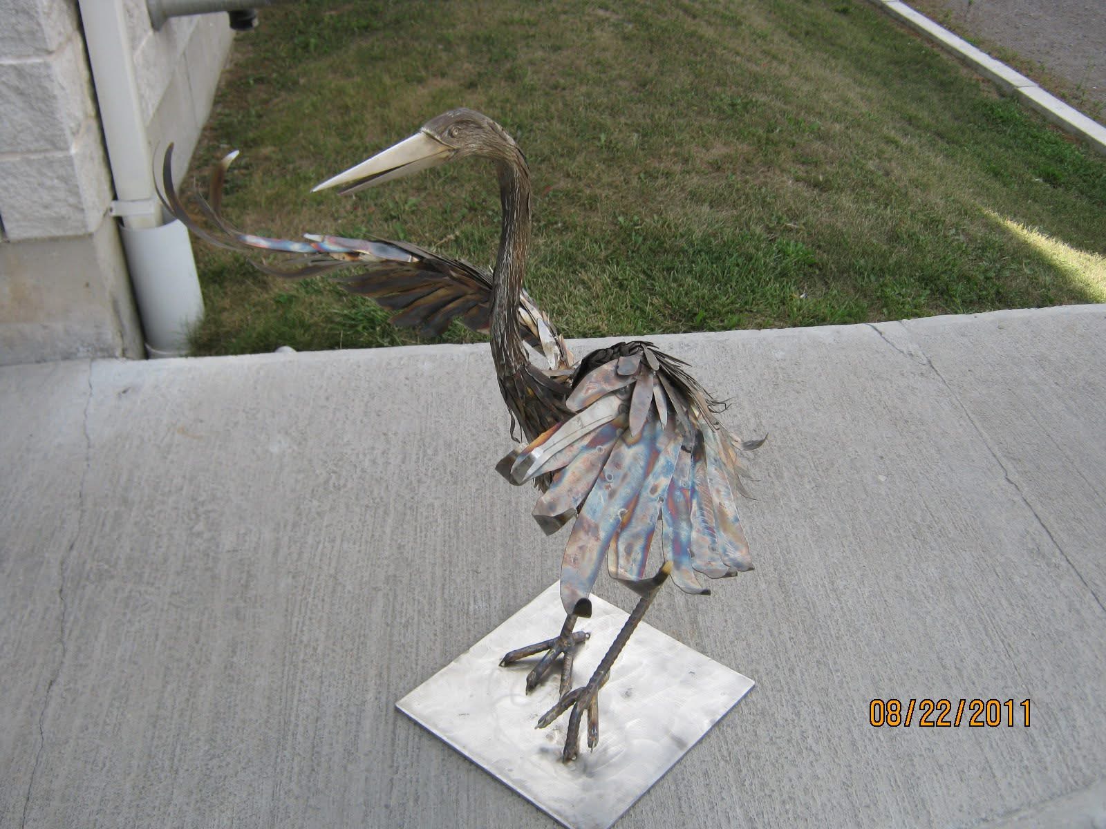 Metal heron sculpture standing