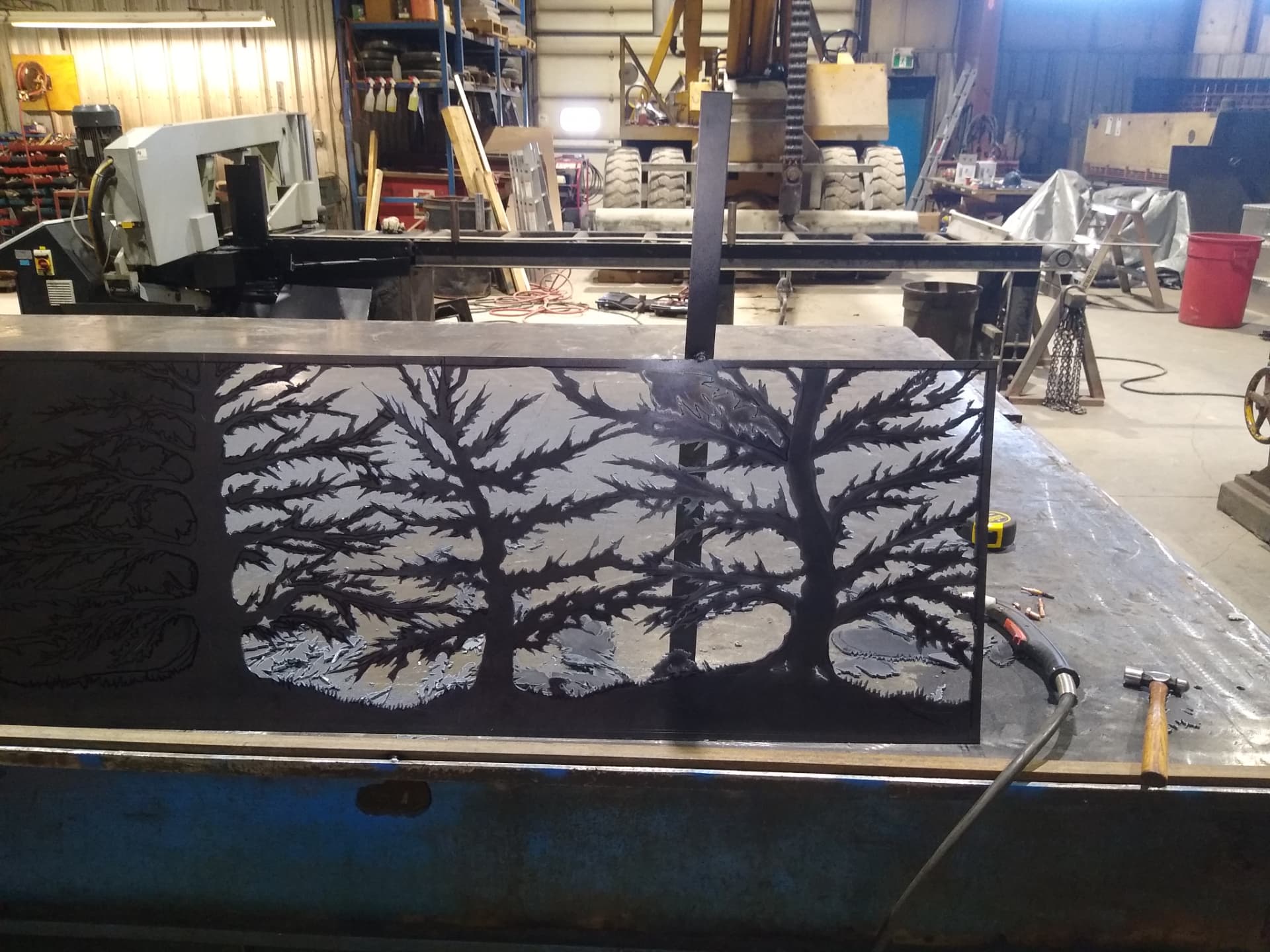 Large tree silhouette metal panel during fabrication