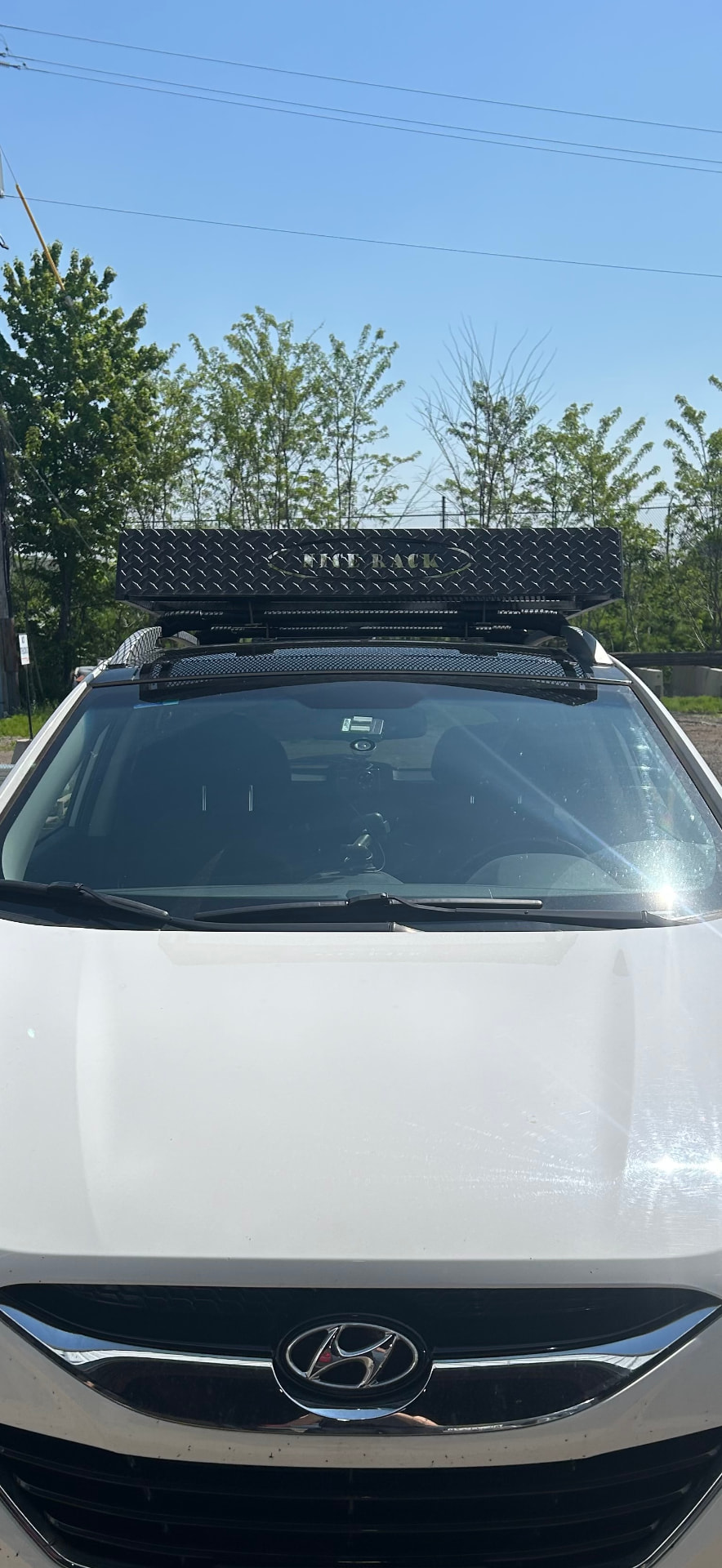 White SUV with custom roof rack front view