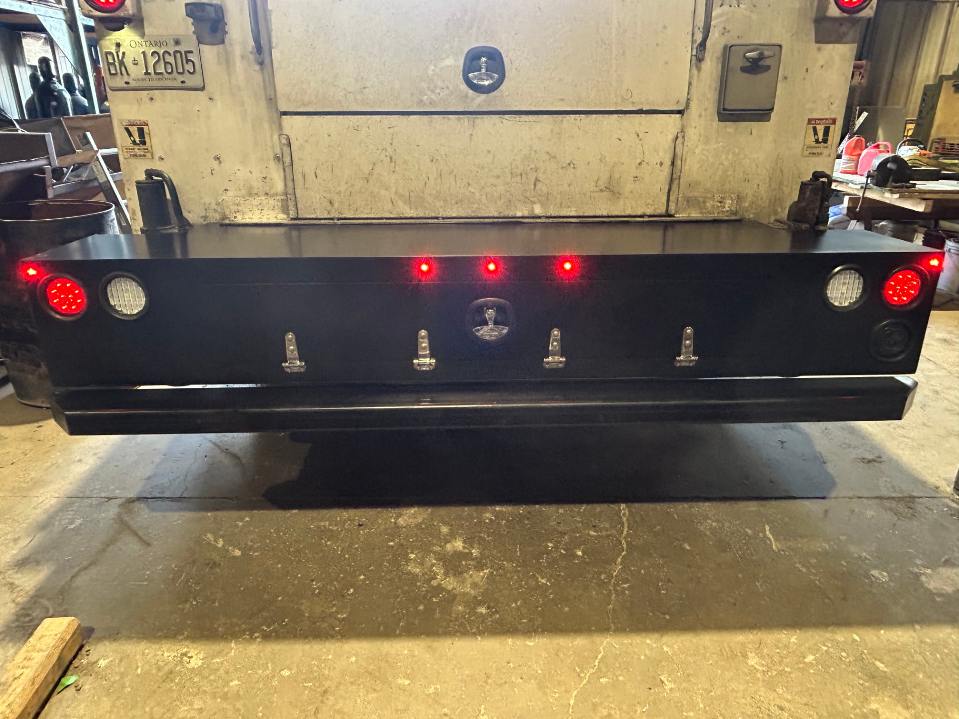 Custom fabricated truck bumper with integrated storage box