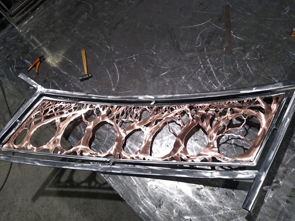 Copper finished tree branch metal panel on a fabrication table