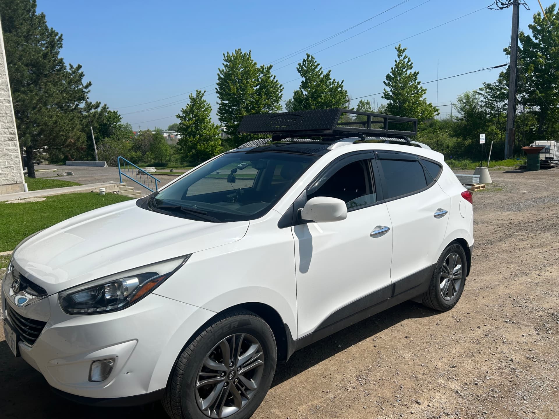 White SUV with custom roof rack side view
